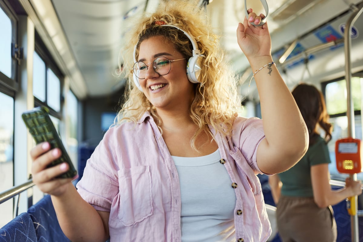 smiling investor looks at smartphone.