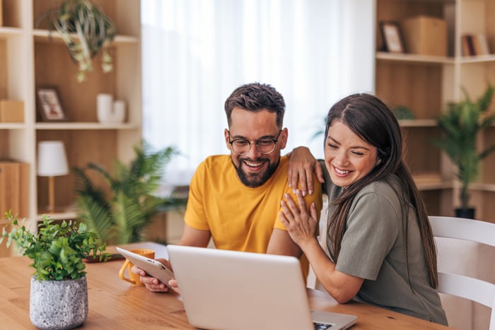 Two people looking at laptop.