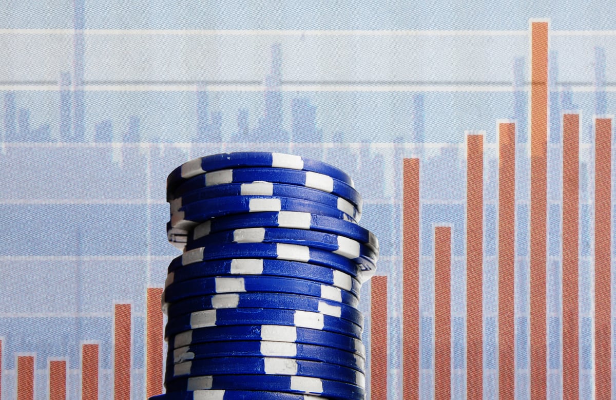 A stack of blue poker chips next to a bar chart, illustrating the power of generating passive income from blue chip dividend stocks.