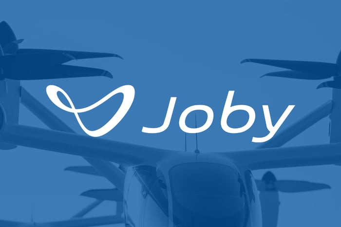 The Joby Aviation logo on a blue backdrop.