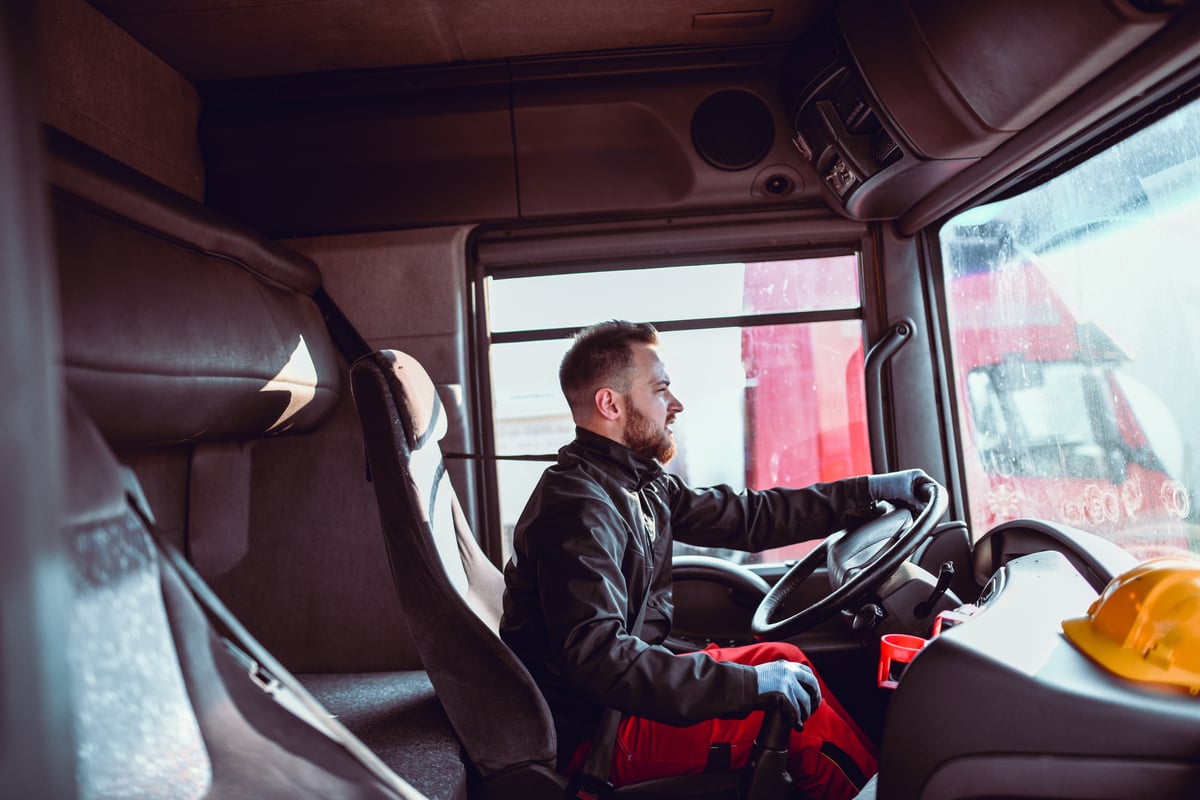 driver steering a commercial vehicle.