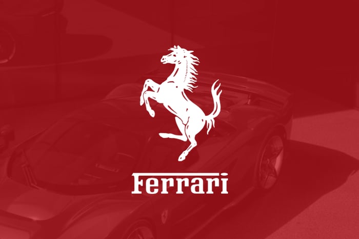 Ferrari logo on red filter with Ferrari car in background.