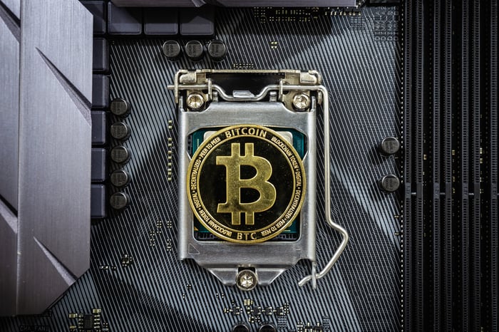Bank vault with Bitcoin logo on door.