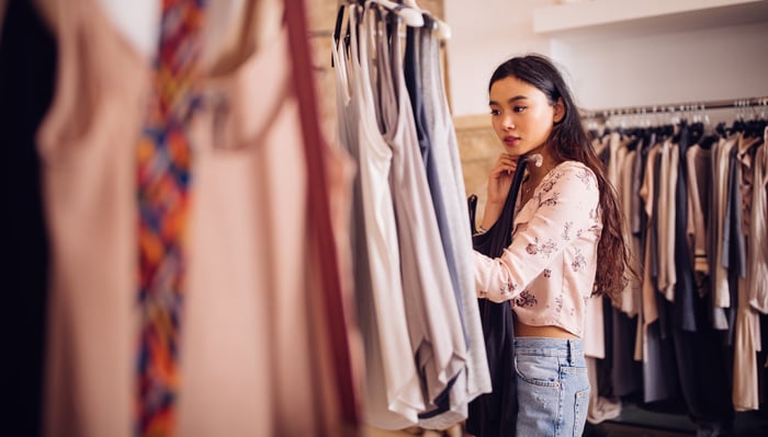 Person shopping for clothes in a retail store.