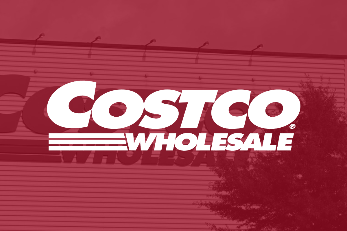 Costco logo on red filter with signage in background_The Motley Fool