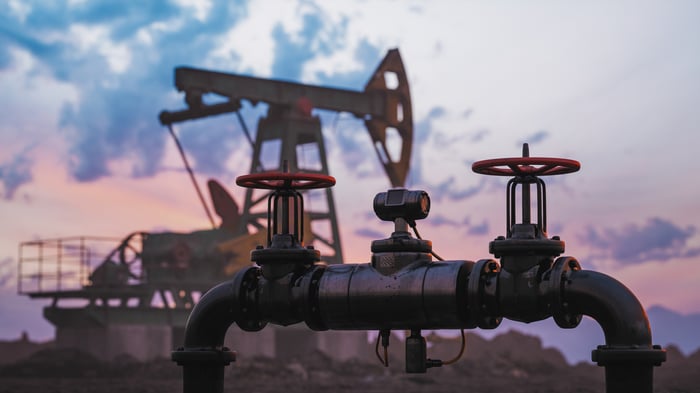 A pipeline with an oil pump in the background.