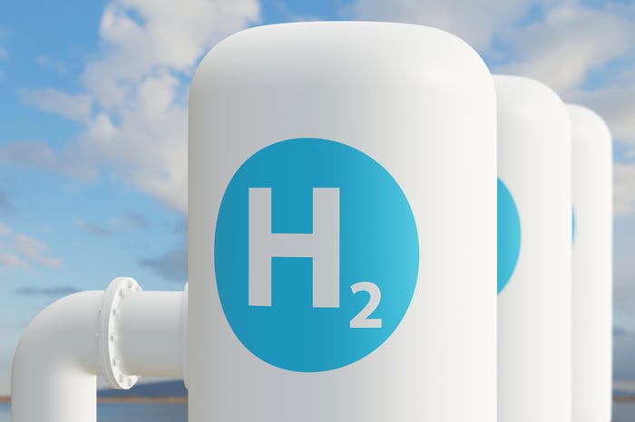 Hydrogen fuel tanks set against a cloudy sky