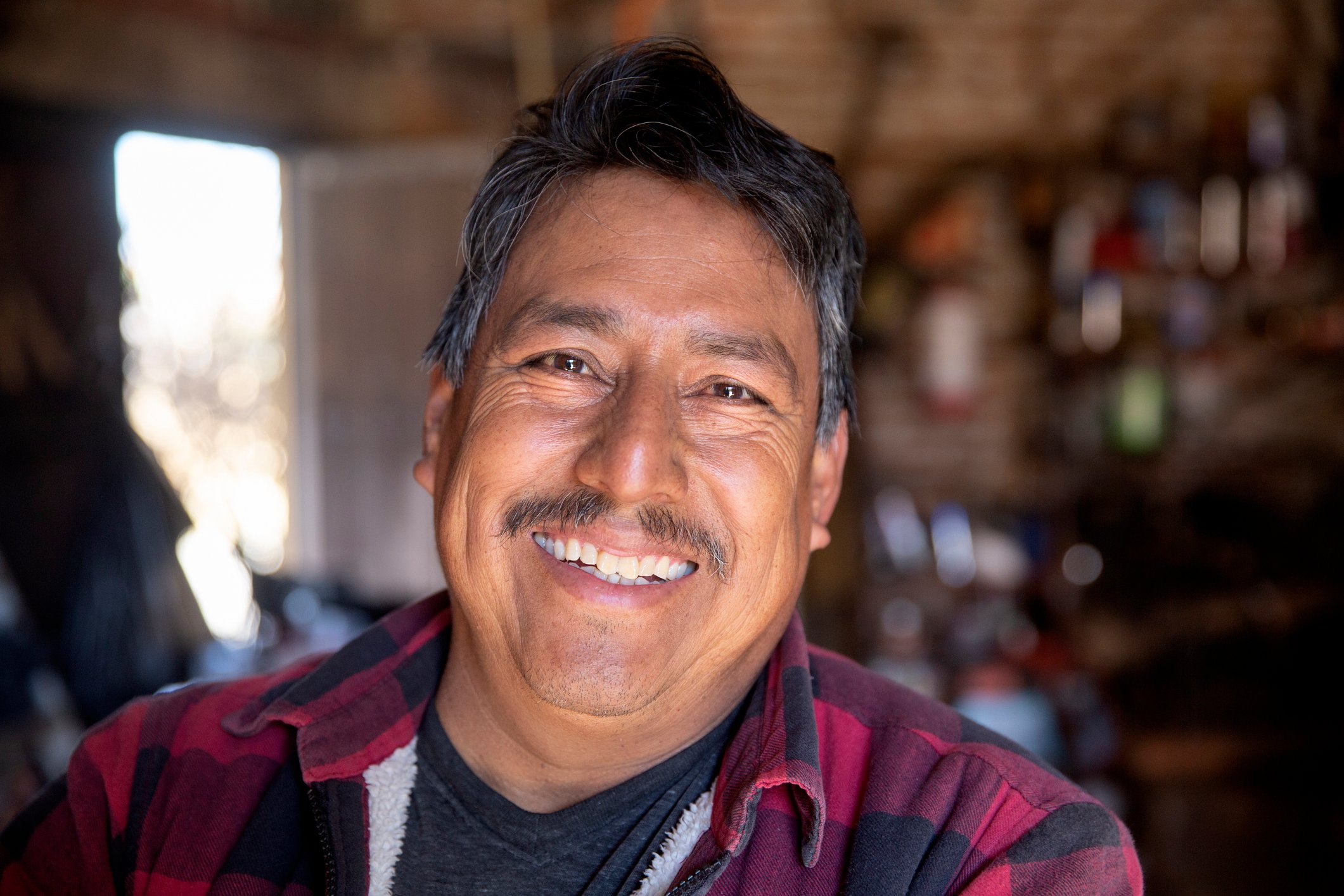 Getty - happy middle aged person in flannel shirt
