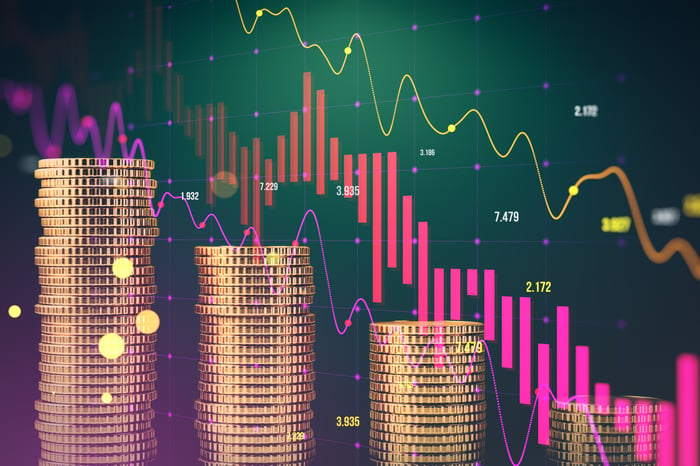 Gold crypto coins and neon trading charts.