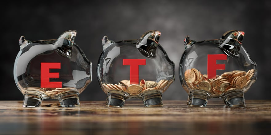 Three glass piggy banks filled with coins.