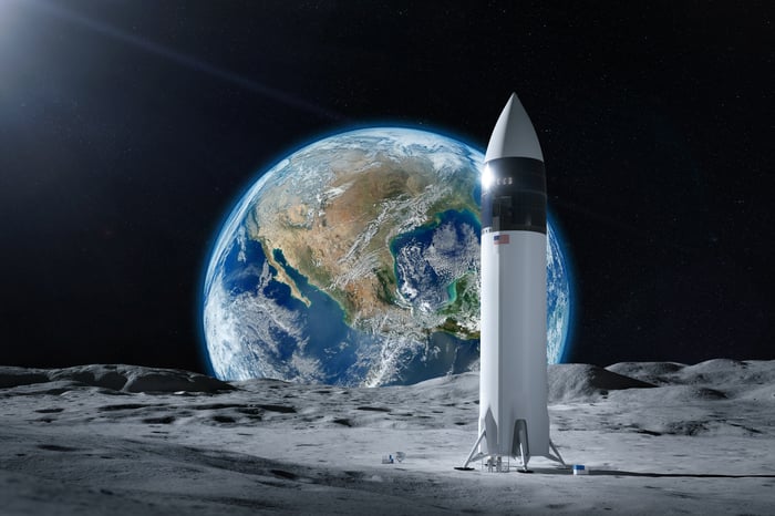 Artist rendering of rocket ship on the moon with Earth in the background.