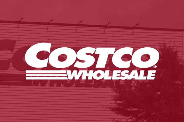The words Costco Wholesale with a Costco building in the background. 