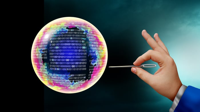 A hand with a needle about to prick a bubble with zeroes and ones.