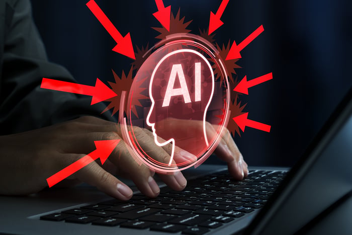 A person typing on a keyboard with the letters AI superimposed over the hands. 