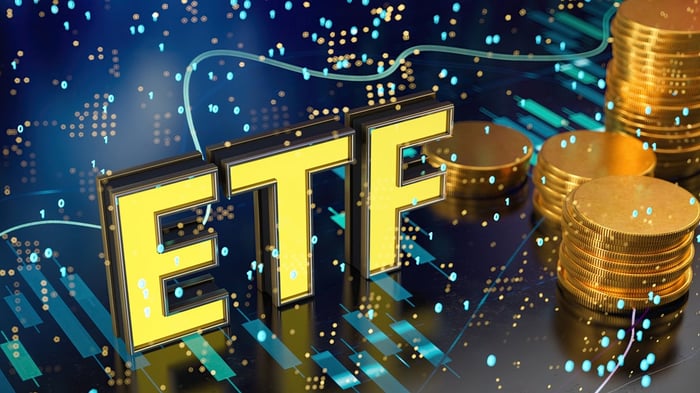 Bright dots of light surrounding the letters "ETF" and a stack of gold coins. 
