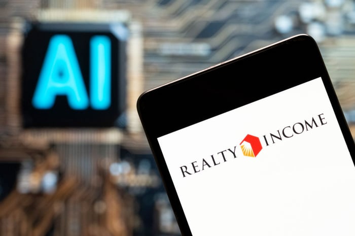 A mobile phone with Realty Income's logo on it.