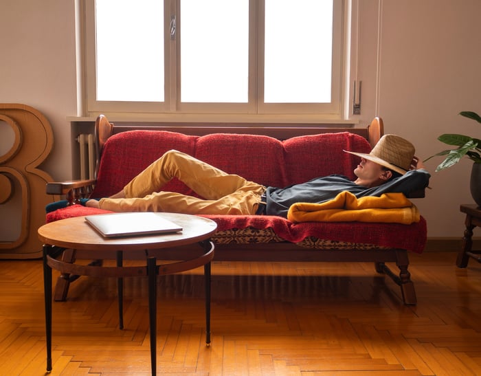 A person napping on a couch.