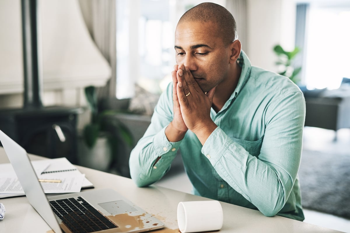 concerned investor works on laptop.