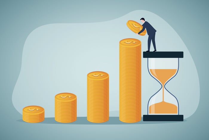 Illustration of a man standing atop an hour glass, adding to ever-larger piles of coins. 