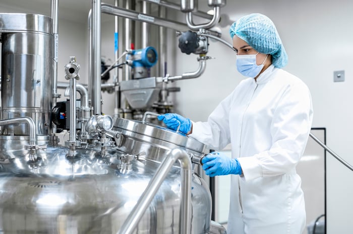 A woman in a drug lab.