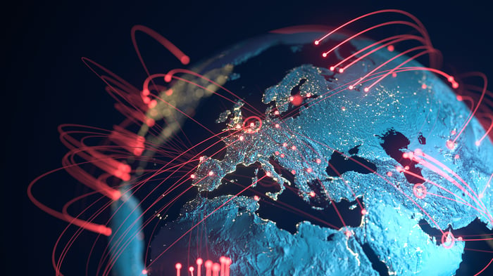 A bunch of red lines going around the globe. 