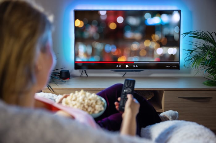 Person streaming content on television.