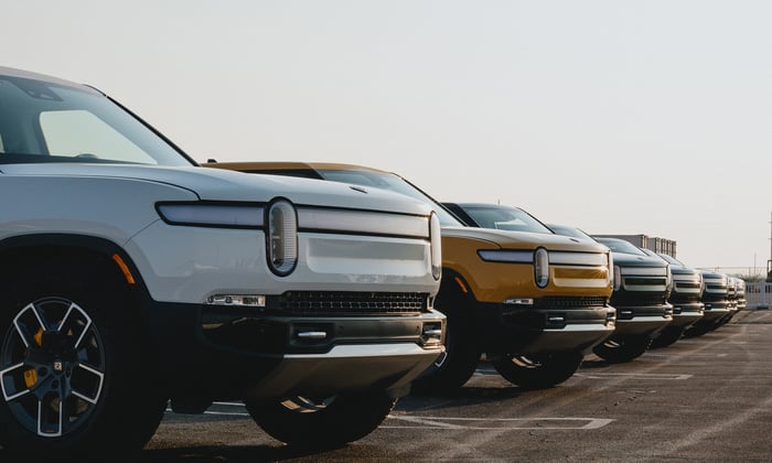Rivian vehicles lined up on pavement.