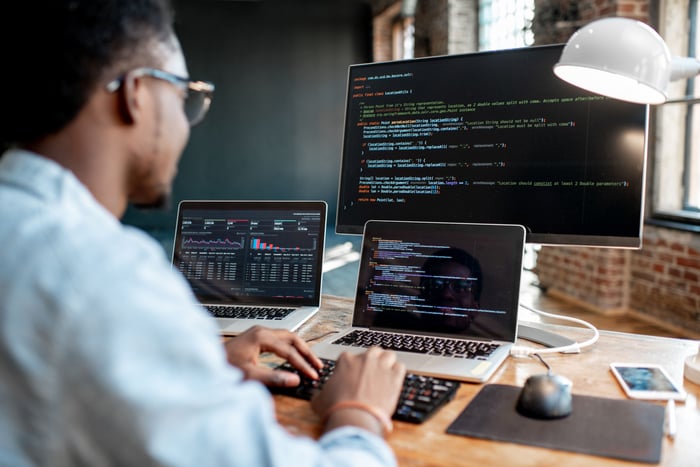 A computer programmer is typing in some code.