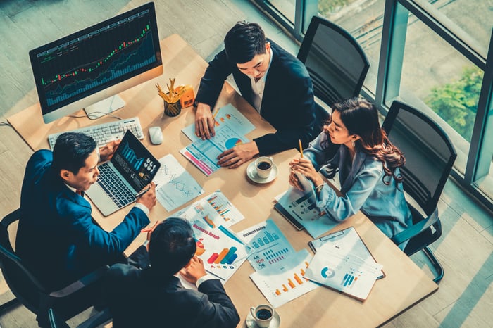 A group of people analyzing investment opportunities. 