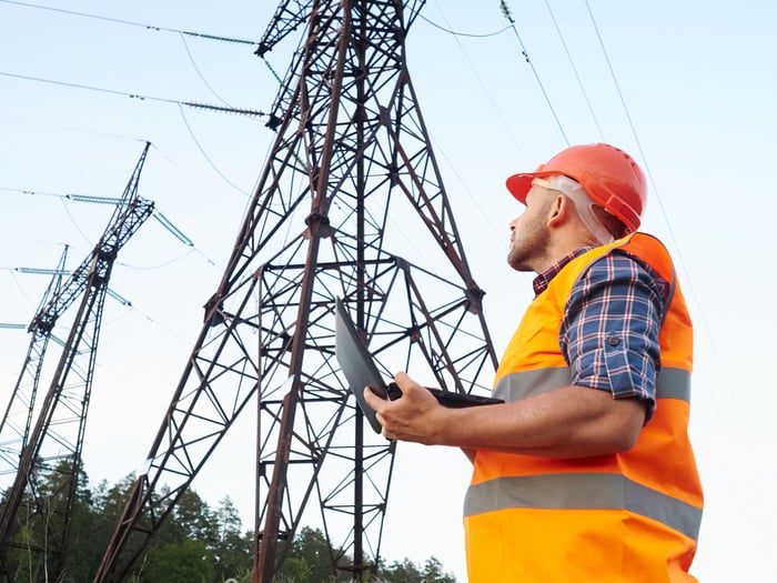 A power line technician is performing an inspection test.