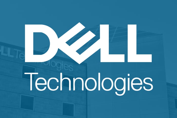 Dell Technologies company name superimposed on a blue background with a picture of a company's building.