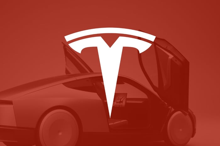 The Tesla logo is shown against a red background.