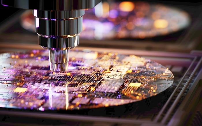 A close-up view of a machine layering chip designs onto a silicon wafer.