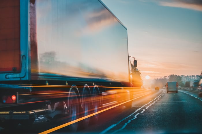 Truck driving down a highway.