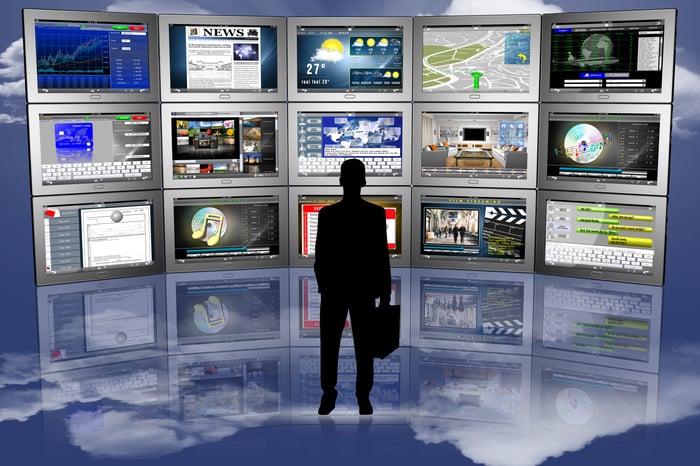 An individual looks at a bunch of screens.