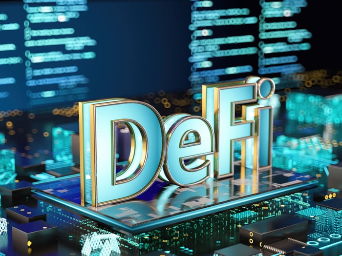 Blue DeFi coin on computer circuit board.