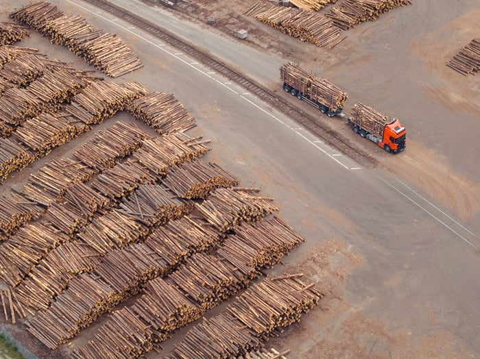 A railroad going through a lumberyard. 