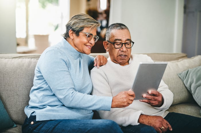 Couple using tablet at home together.