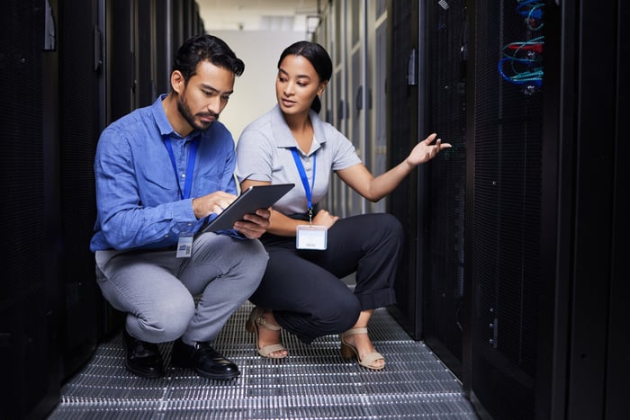 technicians monitor cloud computing equipment.