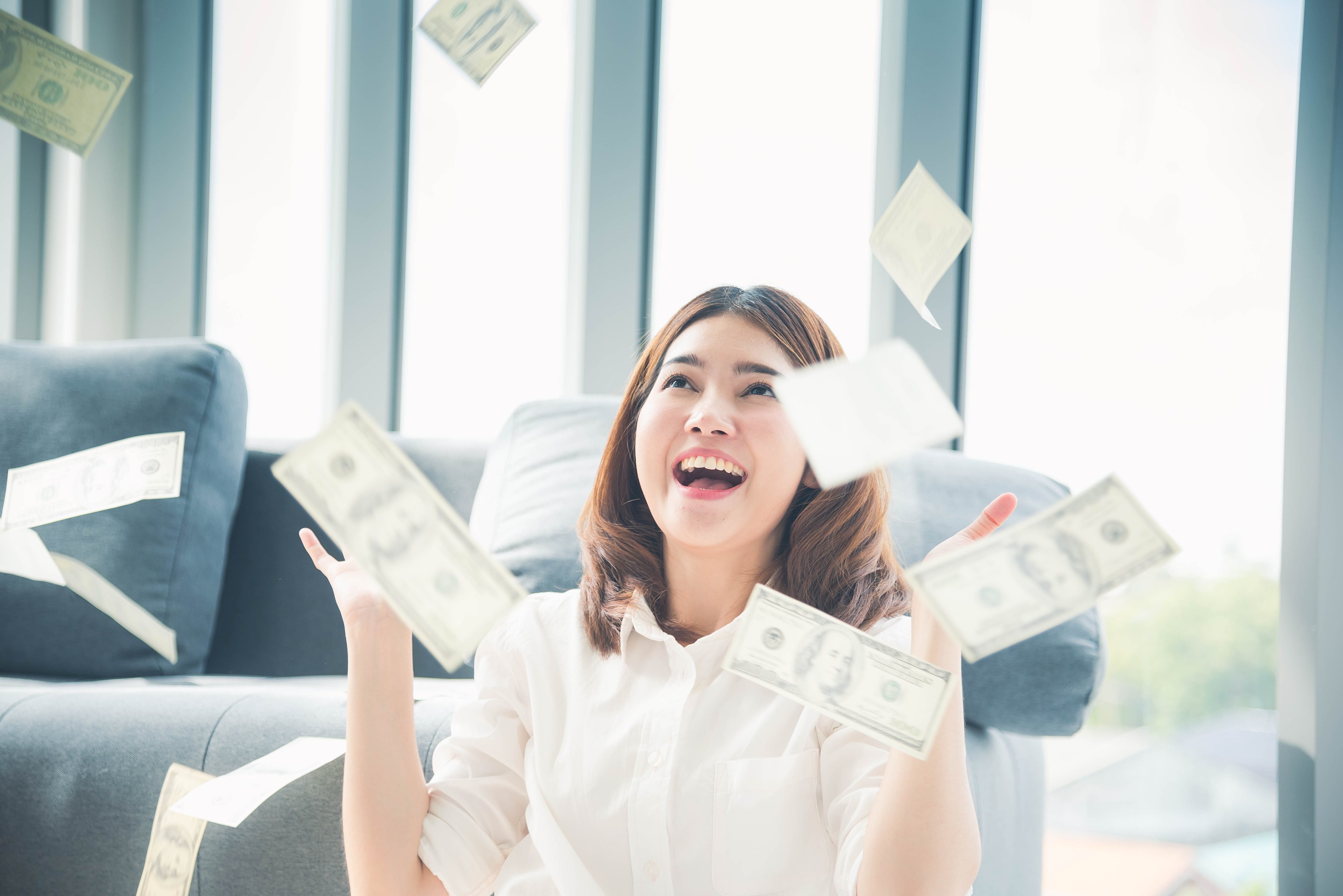 Person throwing money up in the air