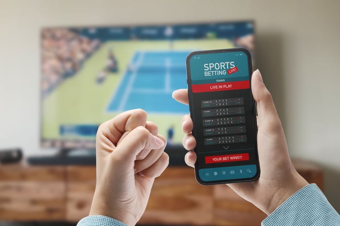 A sports fan is using a mobile app to place a bet on a sporting event.