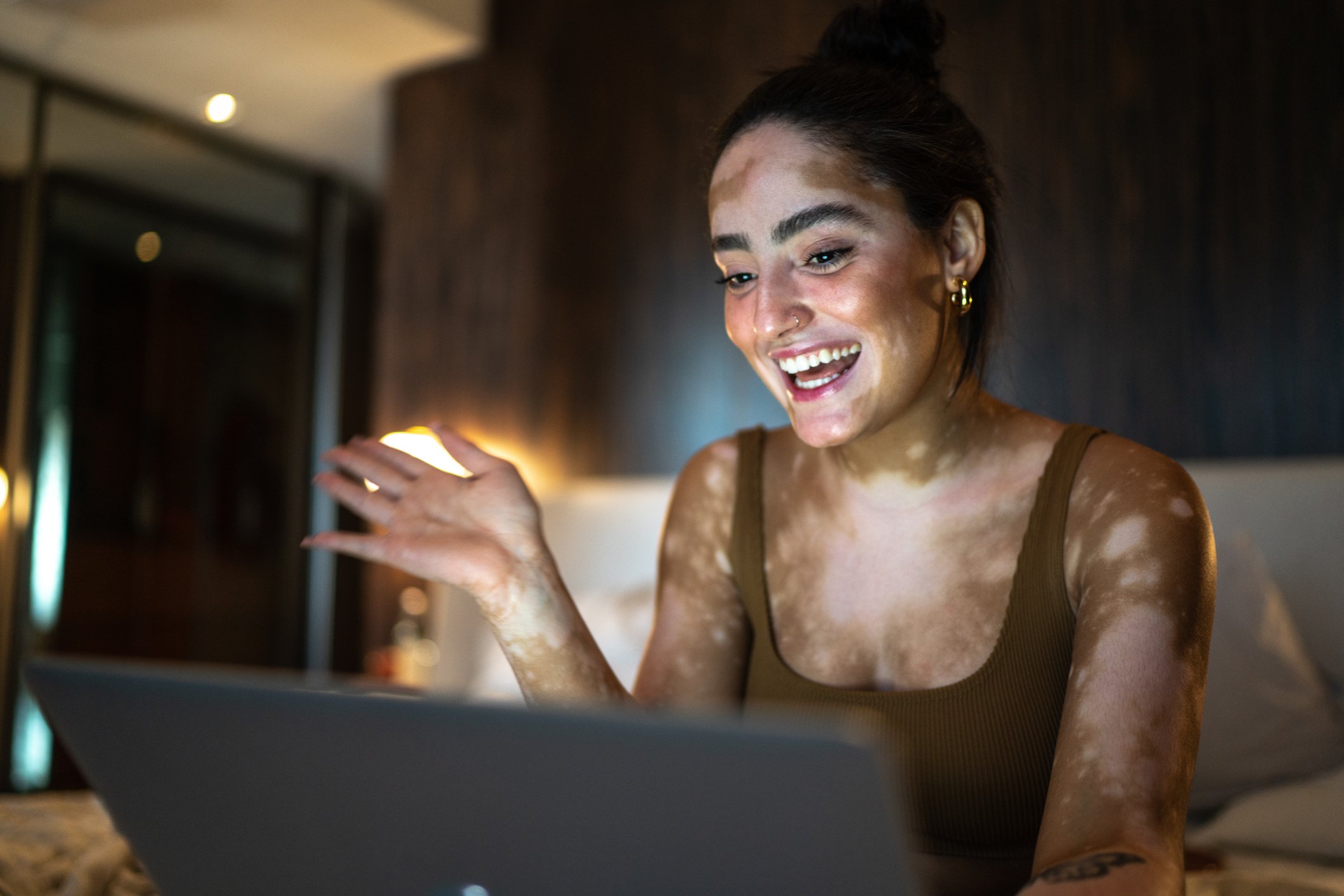 Getty - smiling at open laptop happy surprised impressed pleased