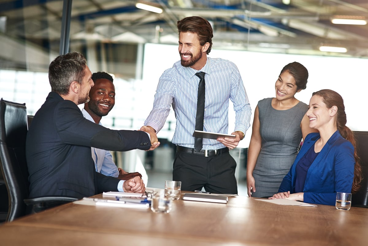 professionals_shaking_hands_in_a_successful_meeting