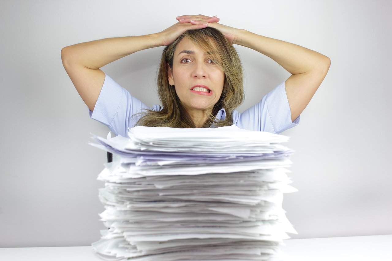 26_10_09 A person with a stack of paper in front of them _MF Dload GettyImages-1249469056-1280x853-c533c3e