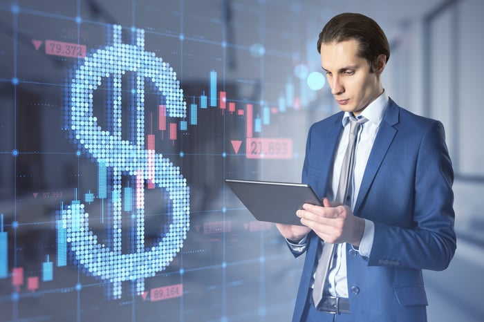 Currency trader with digital chart and screen.
