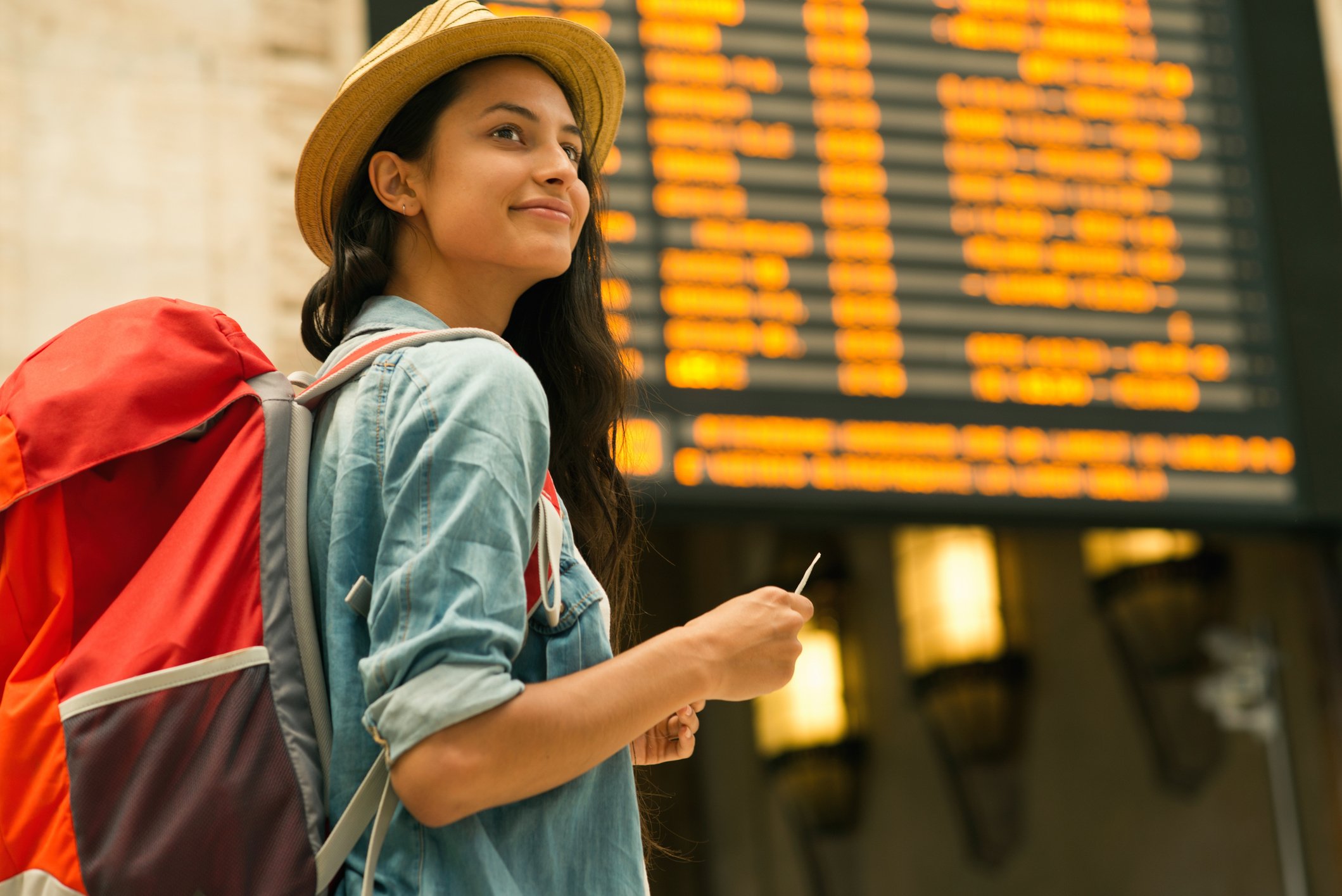 Getty - traveler at train station or airport happy smiling