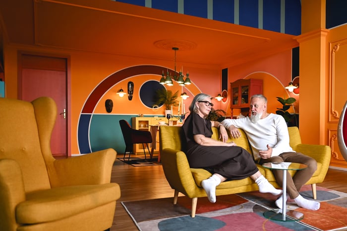 Two people sit in a contemporary living room.