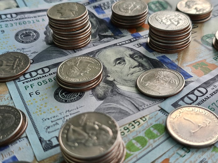 Paper U.S. currency and coins on a table. 