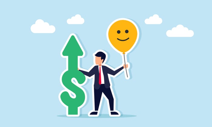 A cartoon illustrates an investor in a business suit holding a "money" symbol with an "up" arrow, and a smiley-face balloon.