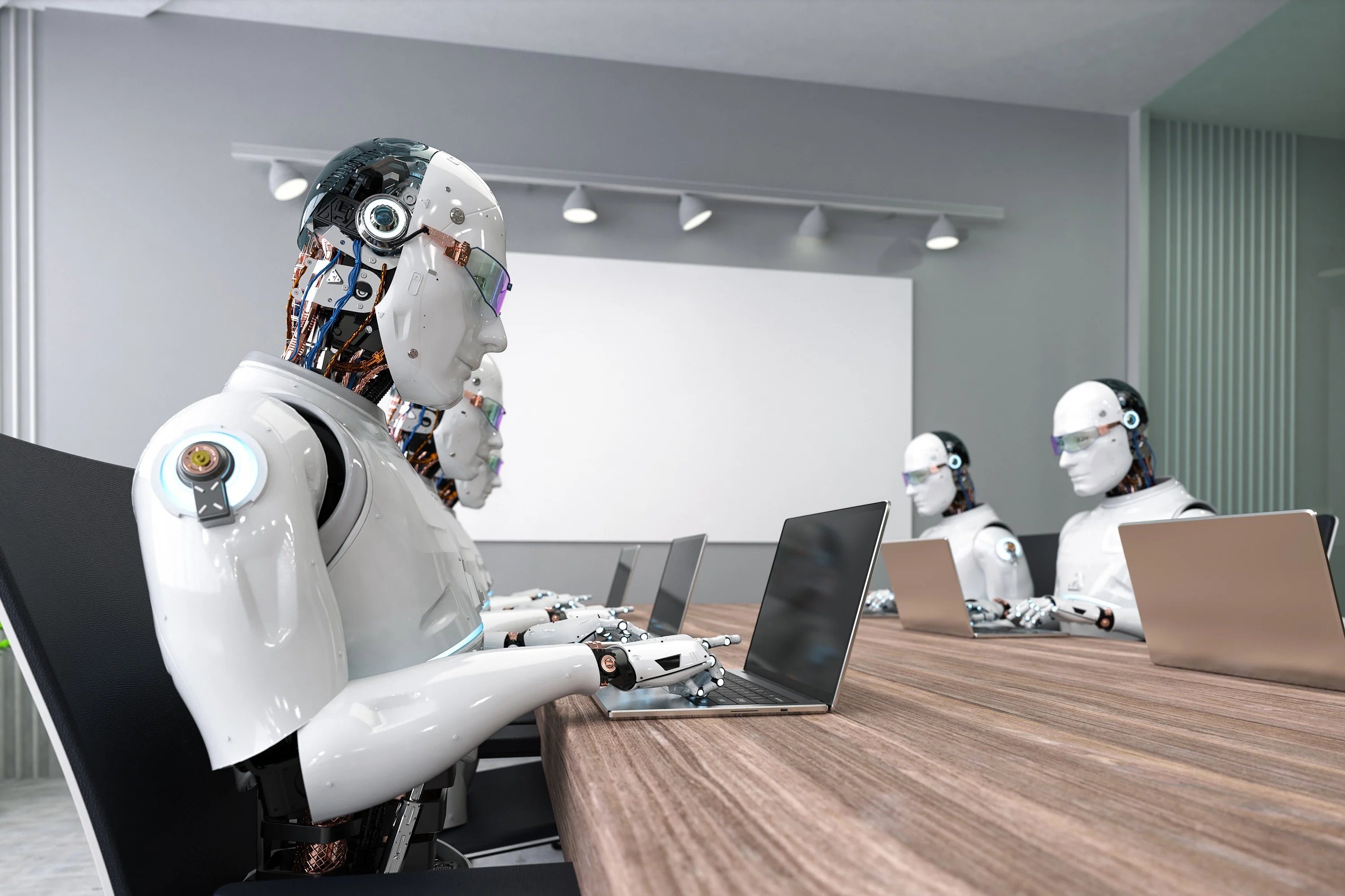 AI robots typing on laptops at conference room table Getty Images